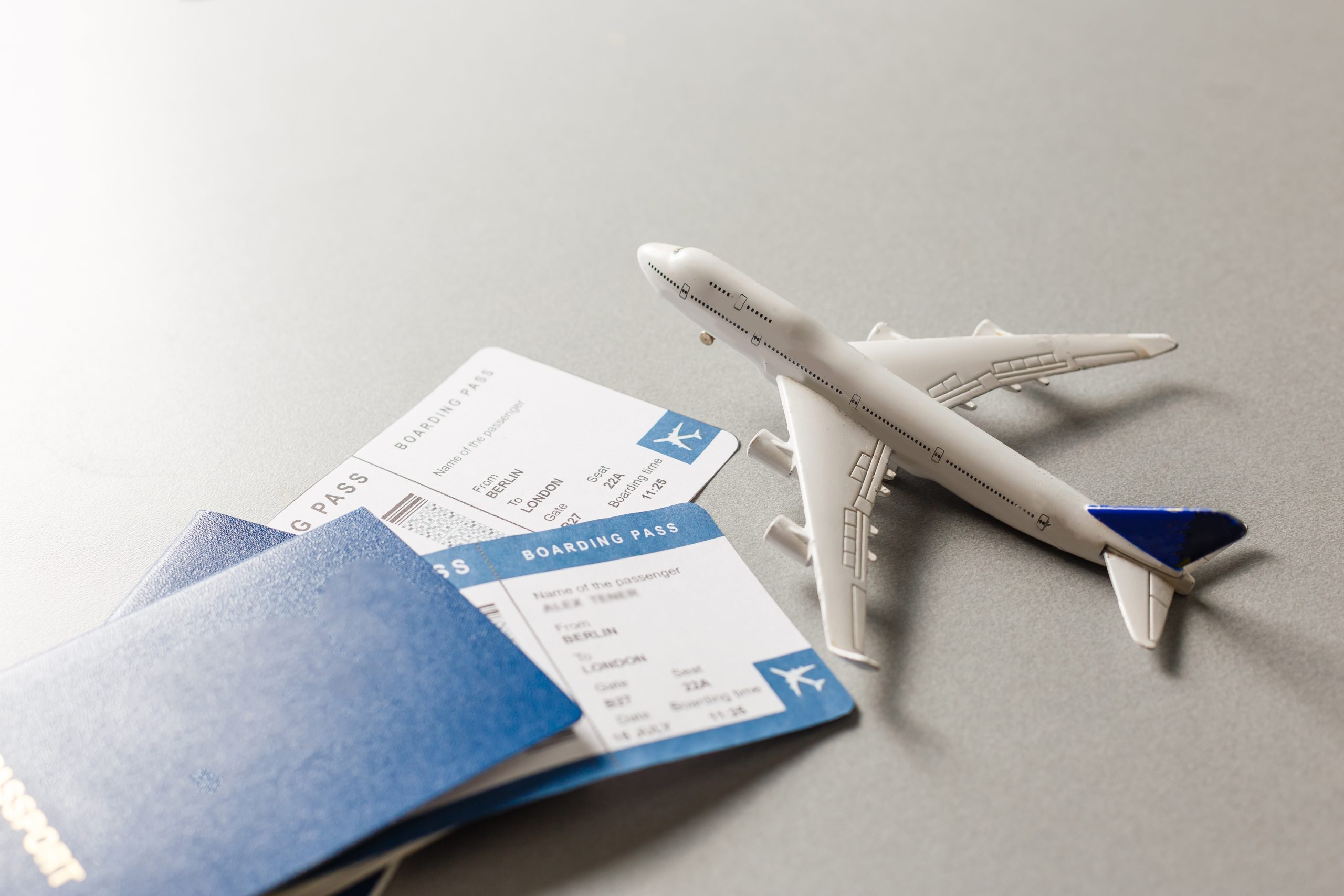 Flight tickets with passports, model of airplane, isolated on white background.