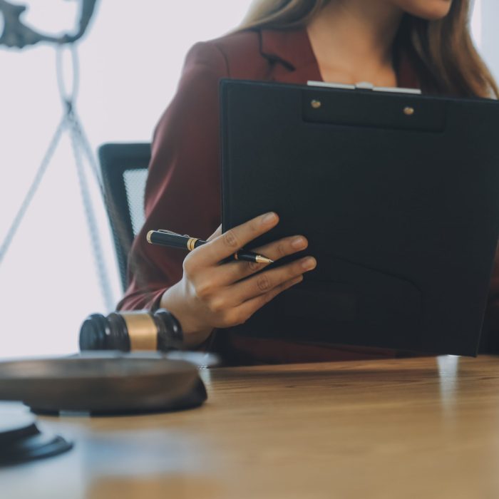 Lawyer, legal advisor, businessman brainstorming information on agreement details Business contracts in legal processing books for accuracy in contract documents. joint financial investment.